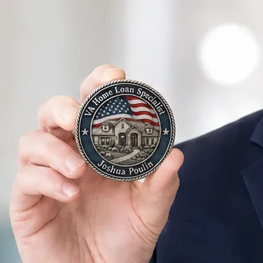 Close-up of Josh Poulin's challenge coin: VA Home Loan Specialist