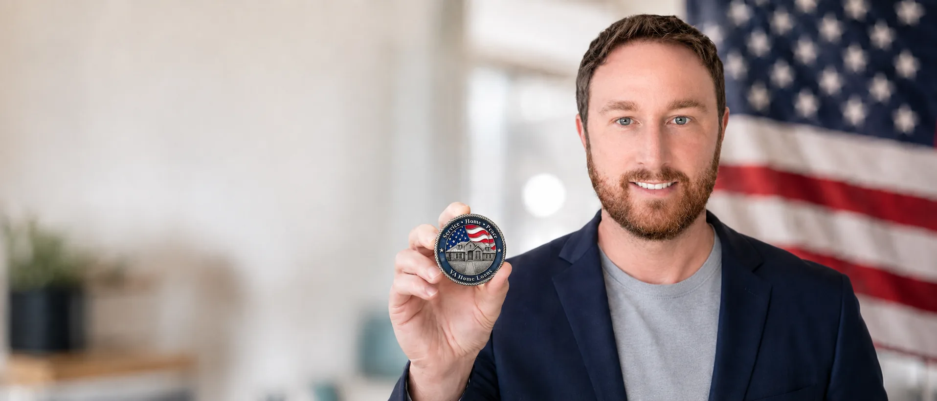 Josh Poulin, Air Force veteran and VA home loan originator, holding his challenge coin in front of an American flag