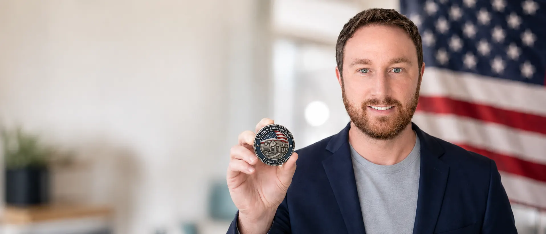 Josh Poulin, Air Force veteran and VA home loan specialist, holding his challenge coin in front of an American flag